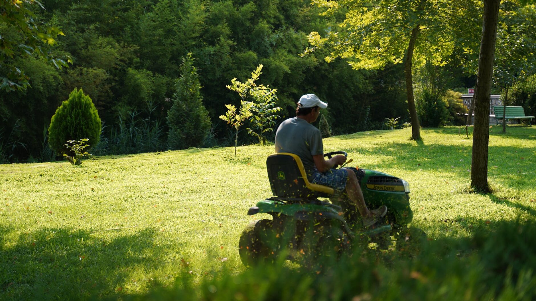 a man mowing the green lawn