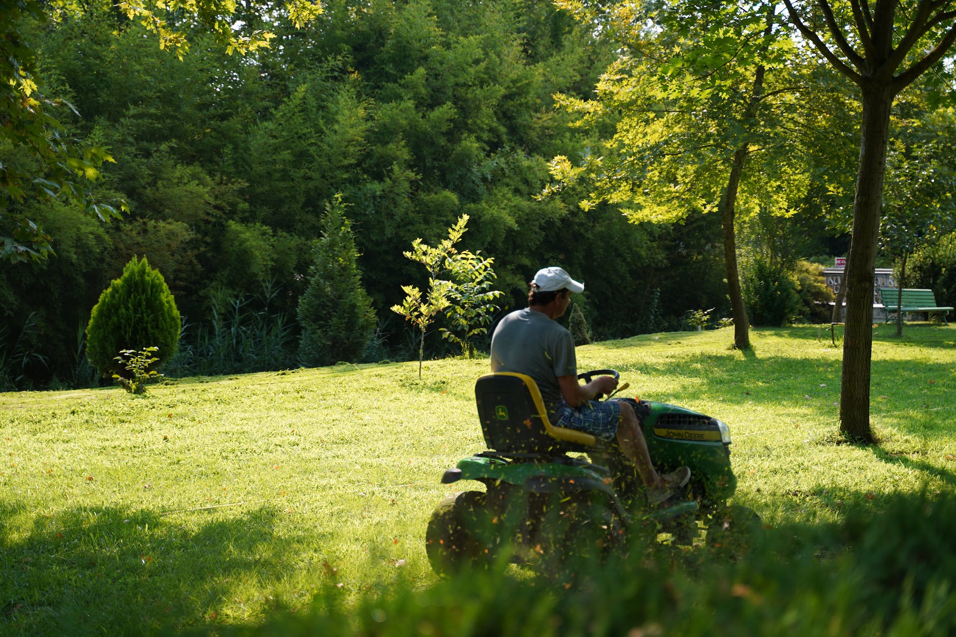 a man mowing the green lawn