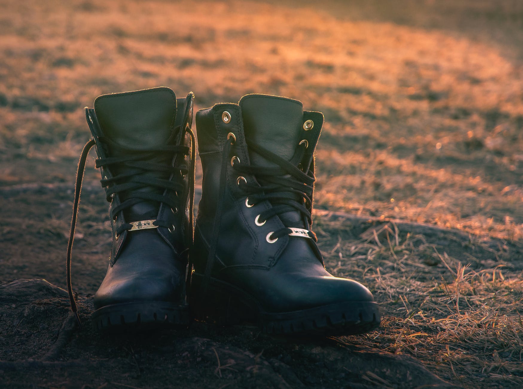 untied leather boots on the ground